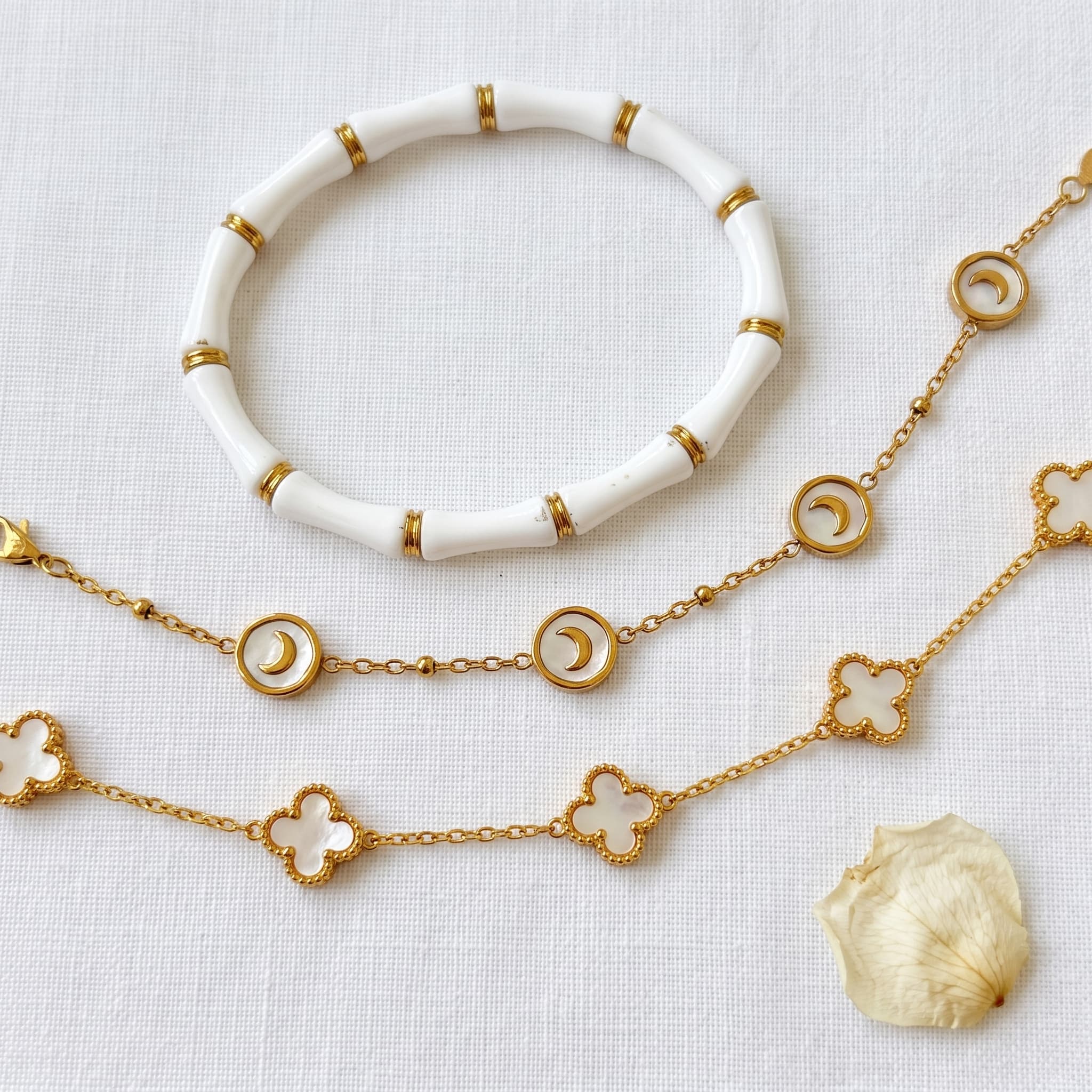 trio of golden charm bracelets
